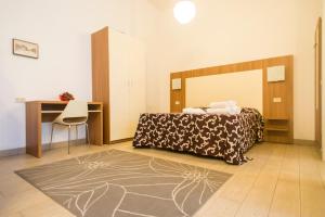 Tempat tidur dalam kamar di Ariston Vacanze