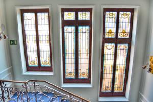a group of four stained glass windows in a staircase at Hotel Alda Mercado de Zamora in Zamora