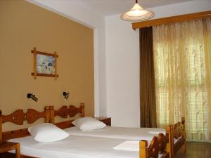 Postel nebo postele na pokoji v ubytování Aiolos House