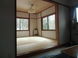 a room with a large mirror on the wall at Raumu San-so in Omachi