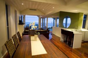 Il comprend un salon avec une table à manger et une cuisine. dans l'établissement Aloha Beachfront Port Fairy, à Port Fairy