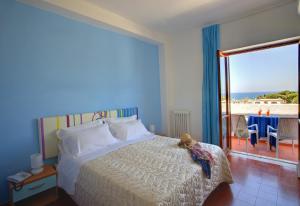 a bedroom with a bed with a view of the beach at Iris Hotel in Ischia +37 photos