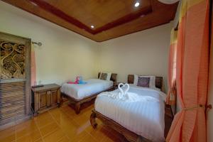 Postel nebo postele na pokoji v ubytování El Greco Bungalows Koh Lanta + 16 fotografií