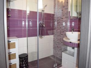 a bathroom with a sink and a glass shower at Apartments Andrea in Podstrana