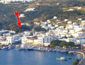 a red kite is flying over a city at Villa Zacharo in Skala