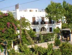 a large white house with trees and bushes at Villa Zacharo in Skala