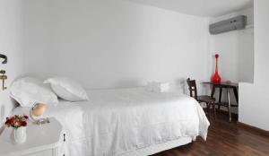 a white bedroom with a white bed and a desk at Casabierta in Buenos Aires +29 photos
