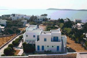 an aerial view of a white house with blue doors at Nissiotiko Studios & Apartments in Drios