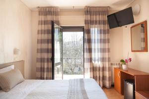 Postel nebo postele na pokoji v ubytování Hotel Fabbrini
