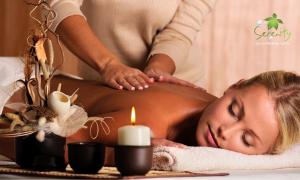 a woman getting a massage in a spa with a candle at Flora Airport Hotel and Convention Centre Kochi in Nedumbassery