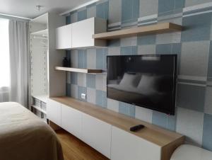 ペトロパブロフスク・カムチャツキーにあるApartment Perfect Homeのベッドルーム1室(壁に薄型テレビ付)