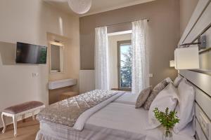 a bedroom with a large bed and a window at Villa EverGreen in Heraklio Town +35 photos