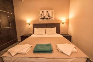 a bedroom with a bed with two towels on it at Gonis Suites in Palaiochóra