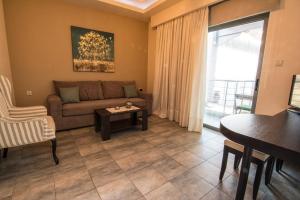 a living room with a couch and a table at Gonis Suites in Palaiochora