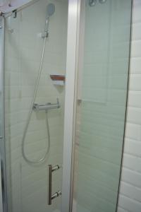 a shower stall with a shower door open at Apartamentos San Agustín in Murcia