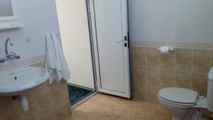 a bathroom with a shower and a toilet and a sink at Guest House Diamant in Sozopol