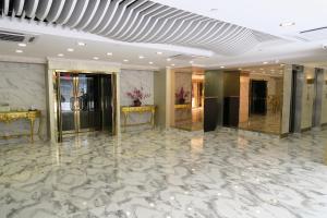 a lobby with a marble floor and gold walls at Best Western Plus Hotel Kowloon in Hong Kong