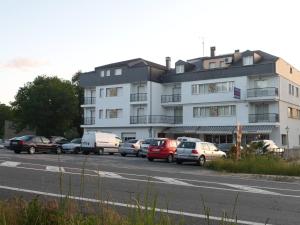 a large white building with cars parked in front of it at Hotel Conde in Taboadela +60 photos