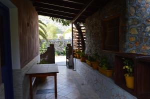 a hallway with a table and potted plants on the wall at "STELIOS & GALINI" in Symi