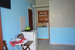 a kitchen with a table and a small kitchen with a sink at "STELIOS & GALINI" in Symi