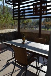 a table with a bottle of wine sitting on a patio at "STELIOS & GALINI" in Symi