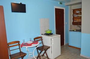 a kitchen with a small table and two chairs and a small table with a kitchen at "STELIOS & GALINI" in Symi