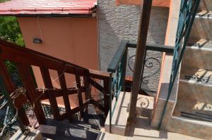 a balcony with a metal railing and a staircase at "STELIOS & GALINI" in Symi