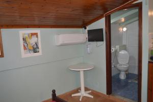 a small bathroom with a toilet and a stool at "STELIOS & GALINI" in Symi