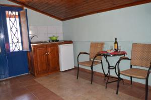 a kitchen with a table and chairs and a sink at "STELIOS & GALINI" in Symi