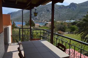 a table on a balcony with a view of a mountain at "STELIOS & GALINI" in Symi
