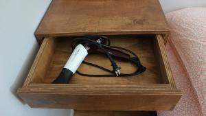 a wooden box with a remote control in it at Zzzip Guesthouse in Hongdae in Seoul