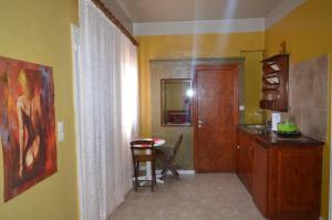 a kitchen with yellow walls and a table and a counter at "STELIOS & GALINI" in Symi +37 photos