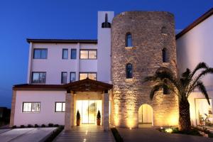 a large building with a large stone tower at Droushia Heights Hotel in Droushia