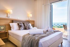 a bedroom with a bed with a view of the ocean at Villas Cape in Minia