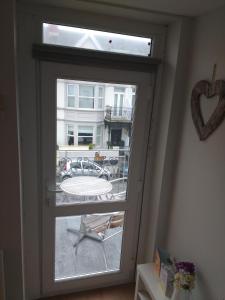 a window with a view of a patio outside at Esplanade Seaside View Apartment in Porthcawl