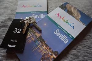 a pair of keys sitting on top of a credit card at Hostal Alamare in Seville