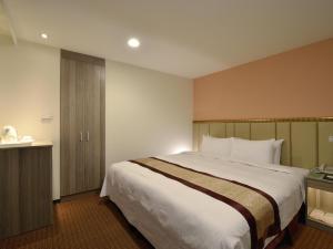 Postel nebo postele na pokoji v ubytování Toongmao Hotel Kaohsiung