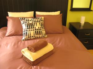 a towel sitting on top of a bed with pillows at Apartment Lisbon Airport in Lisbon
