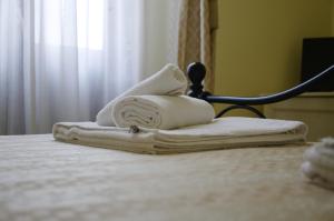 a pile of towels sitting on top of a bed at Residenza Mosco in Tuglie