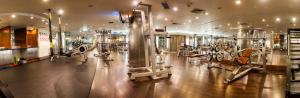a gym with lots of machines in a room at Regent Warsaw Hotel in Warsaw