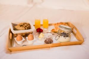 a tray with eggs and other food and drinks at Vila Monet in Laško
