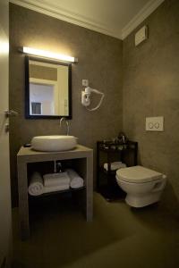 La salle de bains est pourvue de toilettes, d'un lavabo et d'un miroir. dans l'établissement Regal Residence B&B, à Zagreb