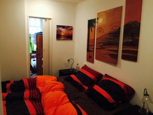 a bedroom with an orange bed with pillows on it at Ferienwohnung 210 Vitamar in Schmarren