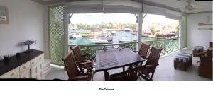 a dining room with a table and a view of a marina at Port St Charles unit 248 in Saint Peter