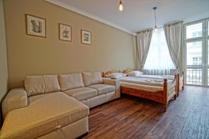 a living room with a couch and a bed at Apartamenty Grodzka 8 in Krakow