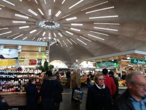 a crowd of people in a market with a large ceiling at Chambres d'Hôtes LA PASTOURELLE Royan centre in Royan