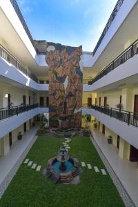 a large stone column in the middle of a building at Avon's Residence in Manado