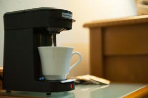 a coffee maker is pouring coffee into a cup at Alicia's Inn in Philipsburg