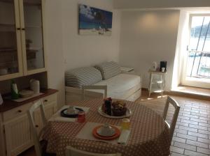 a small living room with a table and a couch at Affittacamere La Lanterna in Portovenere
