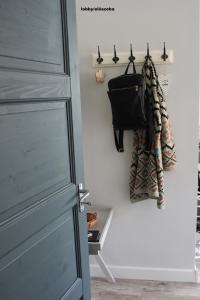 a door with a purse hanging on a wall at Óváros Apartman in Veszprém